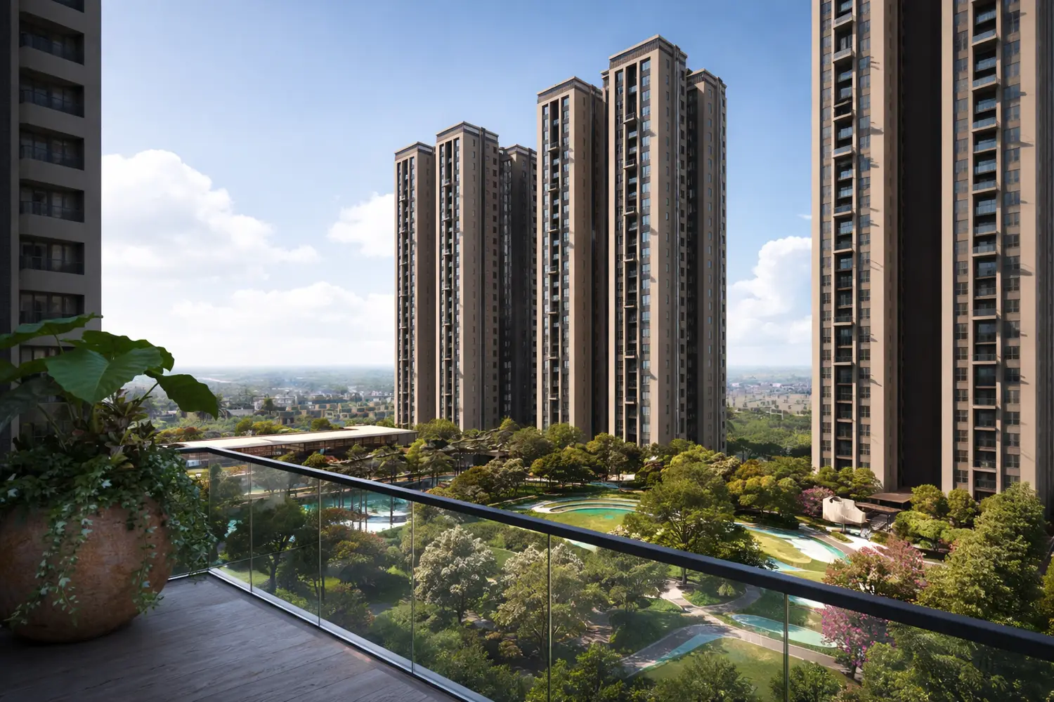 Balcony view at Utpalaa overlooking landscaped gardens, swimming pool, and modern high-rise apartment towers with an open city skyline.