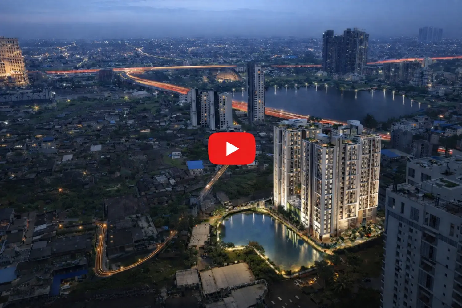Aerial night view of the Utpalaa residential project highlighting illuminated high-rise towers beside a water body, surrounding cityscape, and major road connectivity, with a video walkthrough play icon overlay.
