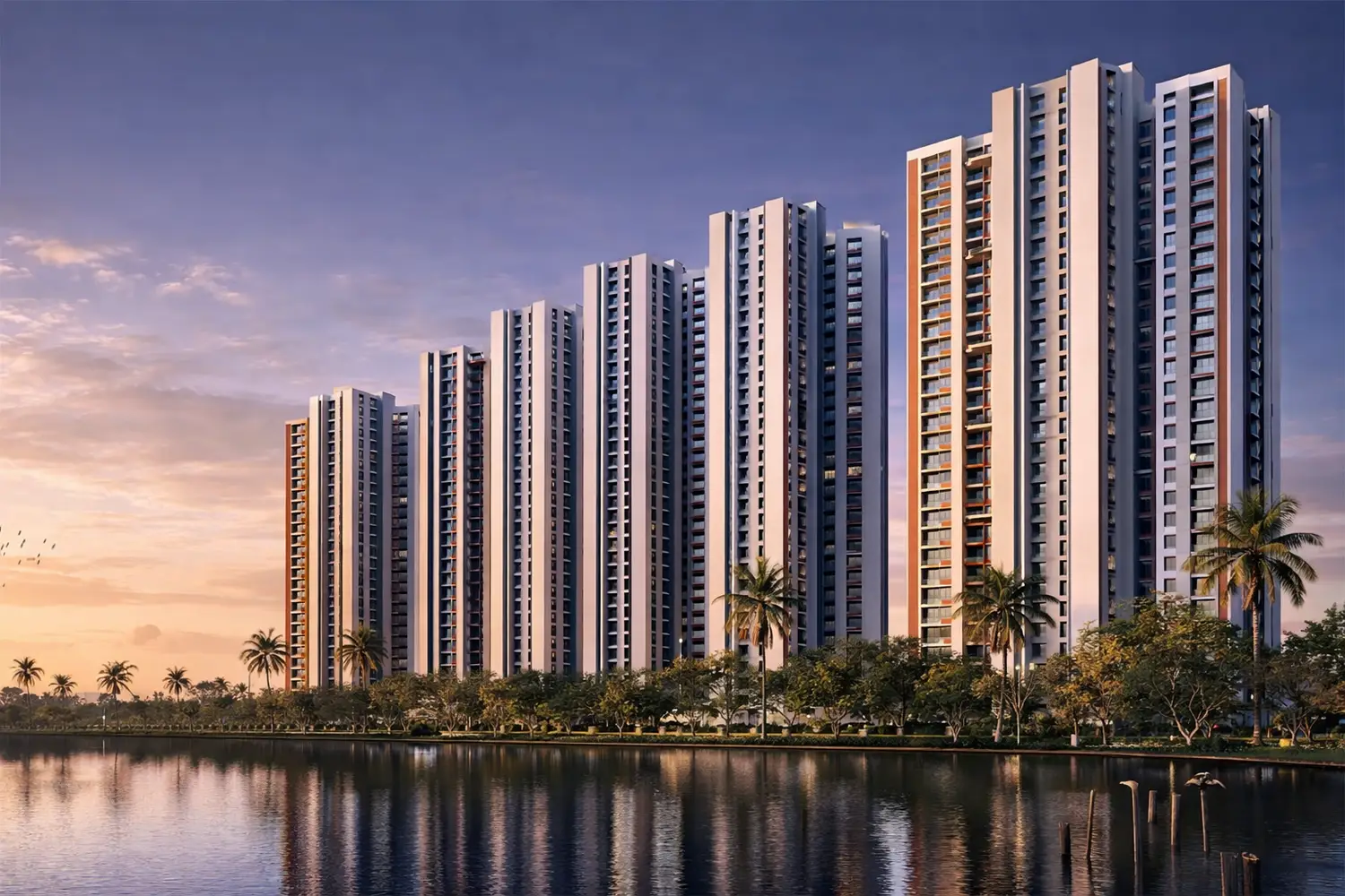 Front view of DTC Capital City featuring modern high-rise residential towers, landscaped greenery, and driveway with vehicles.