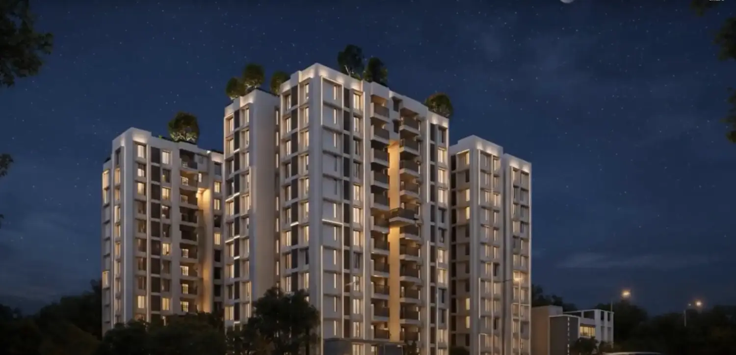 Purti Tatsam premium residential apartments with contemporary architecture, lit balconies, and landscaped surroundings at night.