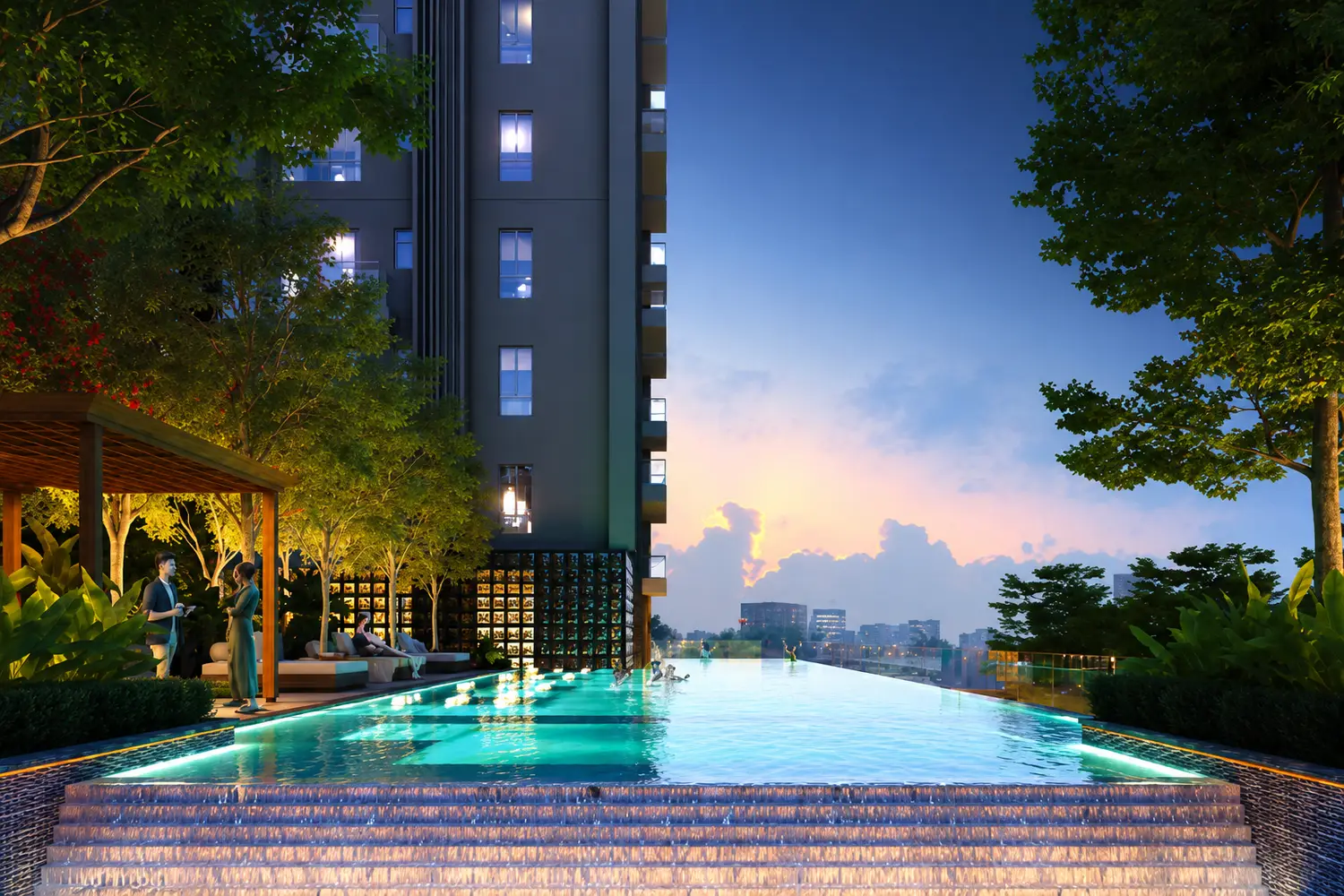 Infinity swimming pool at Vinayak Amara with landscaped surroundings, elegant lounge seating, and serene sunset views.