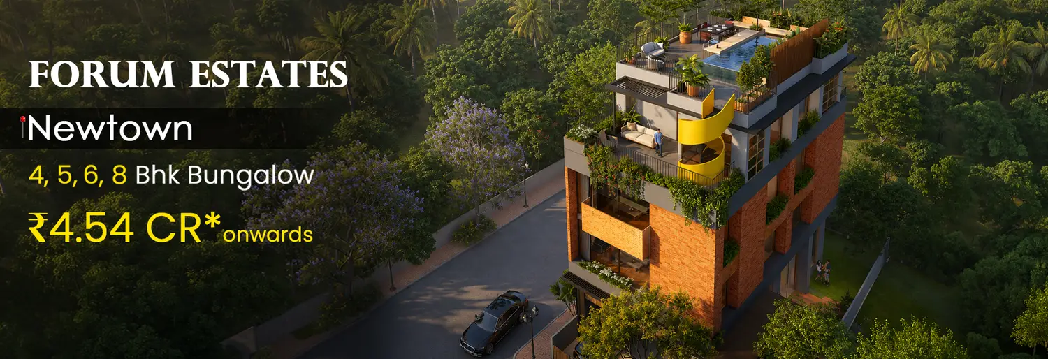 Aerial view of Forum Estates, an exclusive luxury residential development featuring a contemporary multi-storey building with warm brick and glass architecture, lush landscaped terraces, a rooftop infinity pool, private outdoor spaces and a signature yellow spiral staircase, surrounded by dense tropical greenery and wide tree-lined roads.