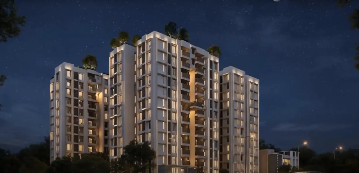 Purti Tatsam premium residential apartments with contemporary architecture, lit balconies, and landscaped surroundings at night.