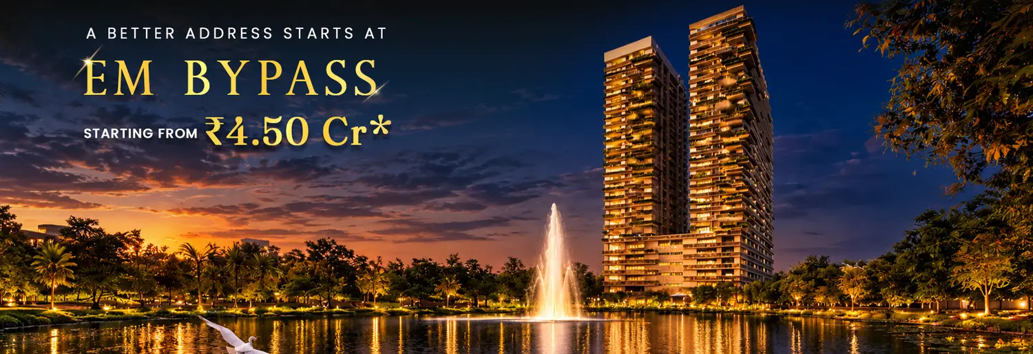 Sunset view at Udyatt overlooking landscaped gardens, swimming pool, and modern high-rise apartment towers with an open city skyline.