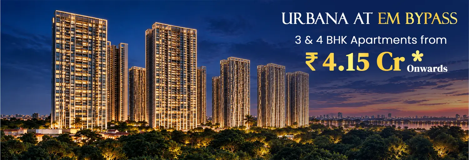 A cluster of modern high-rise residential towers at Urbana rising above lush green surroundings in Kolkata, illuminated by warm golden sunlight under a partly cloudy sky, showcasing a serene and upscale urban landscape.