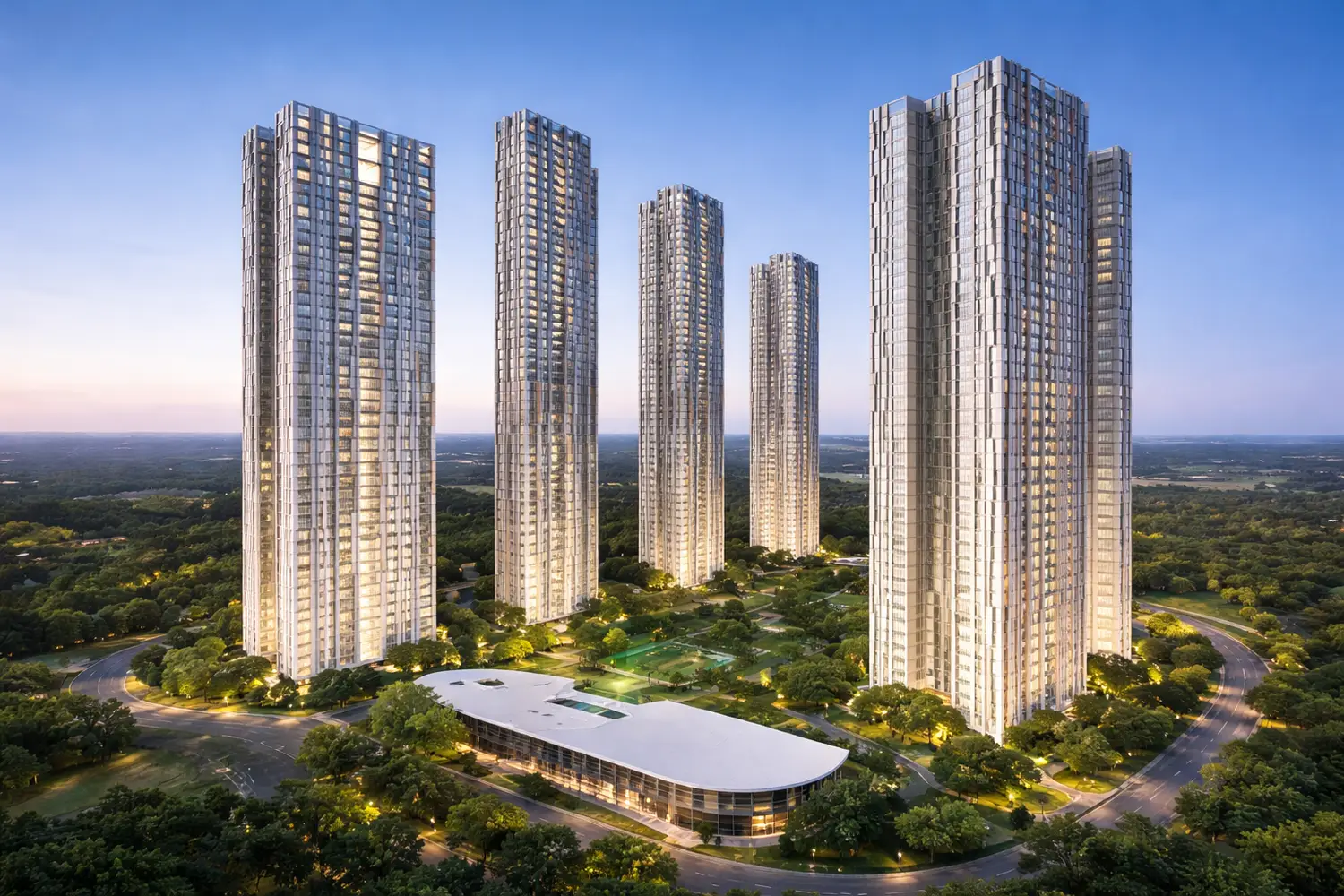 Modern high-rise residential towers of Urbana project surrounded by lush green landscapes, landscaped gardens, and a central clubhouse, captured during twilight with illuminated buildings and clear sky.