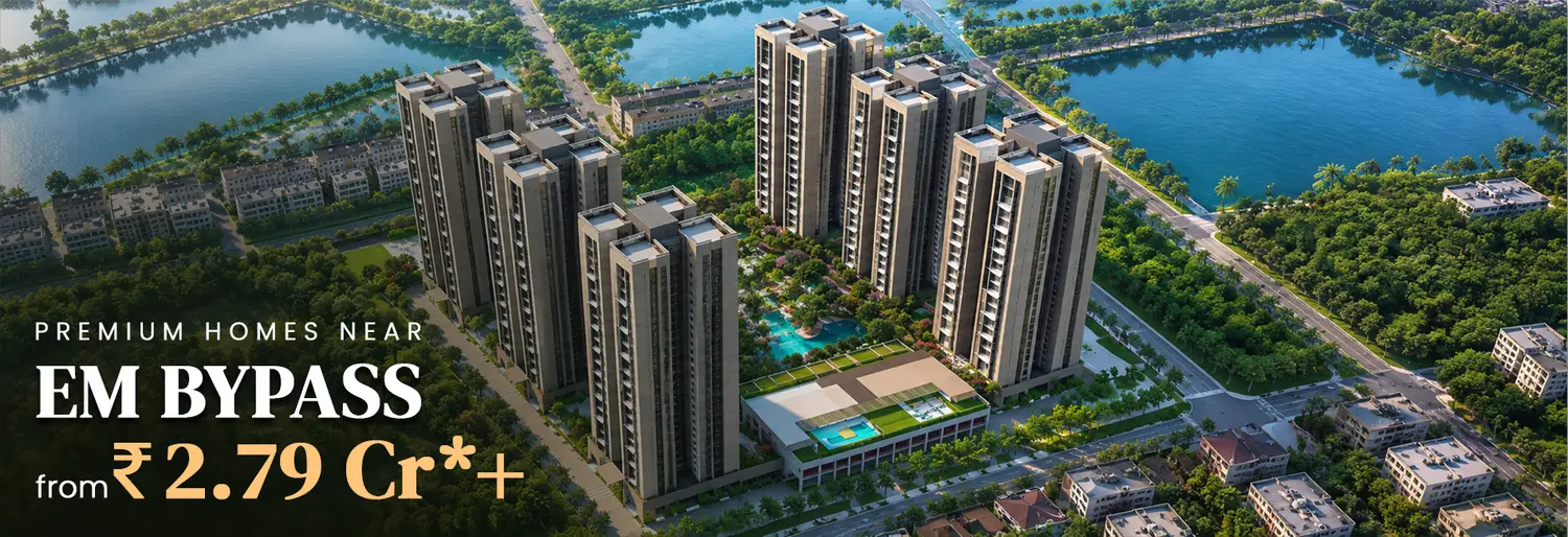 Ambuja Utpalaa premium homes near EM Bypass, Kolkata, featuring elegant high-rise towers overlooking a serene landscaped lake, with homes starting from ₹2.23 Cr.